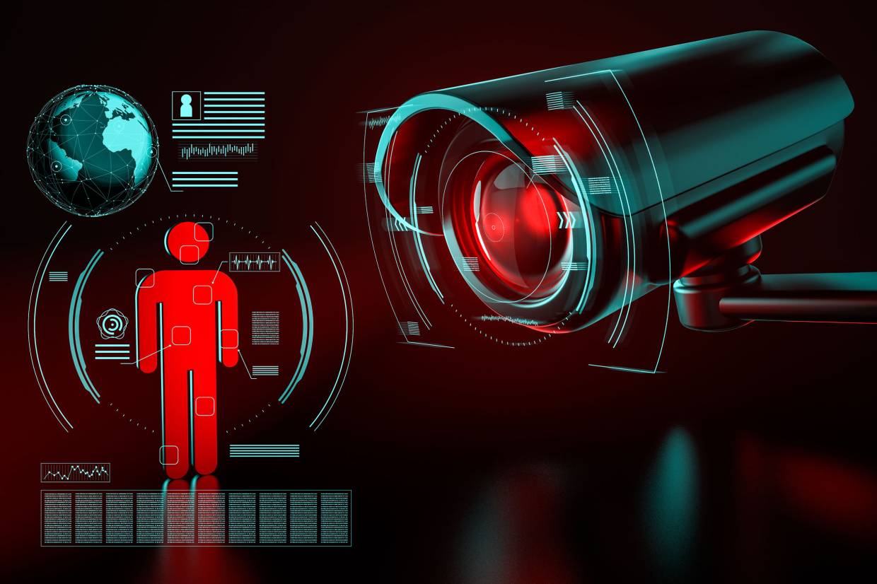 Big surveillance camera is focusing on a human icon as a metaphor of collecting data on society by surveillance systems. 3D rendering. Credit 123rf.com
